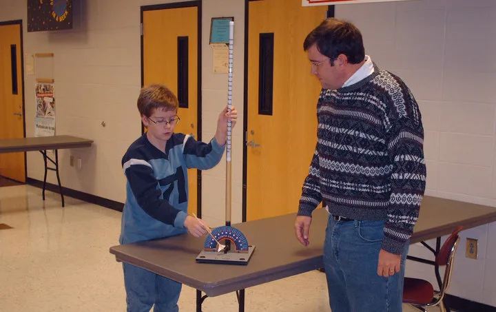 teacher and student classroom science lesson